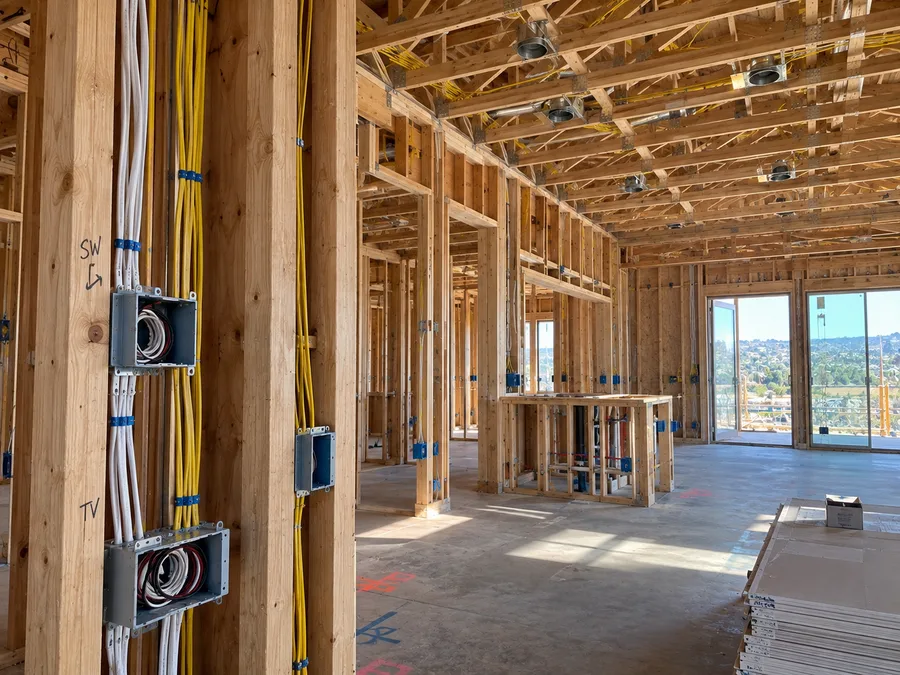 Electrical rough-in wiring and boxes installed in a framed new-construction home